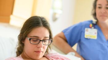Parent and new born and physician near by