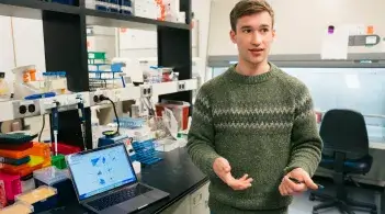 Remi stands in a lab