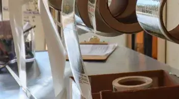 rolls of product labels hanging on a wall