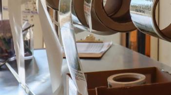 rolls of product labels hanging on a wall