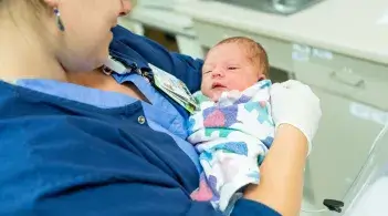 Provider holding new born 