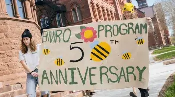 students with banner for 50th anniversary of environmental program