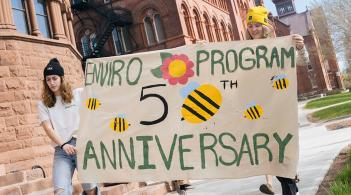 students with banner for 50th anniversary of environmental program