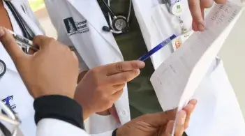 Clinicians looking at paper