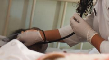 doctor using stethoscope on patients neck