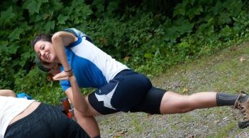Exercise coach demonstrating a stretch