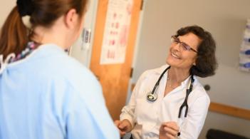 Nurse practitioner talks with patient