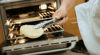 Bread coming out of oven