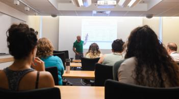 group of learners sit in front of a person giving a lecture