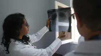 two doctors in a rural clinic review a lung xray