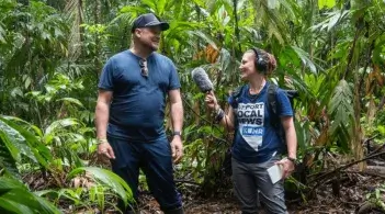 University of Nevada, Reno student Kat Fulwider, reporting from Costa Rica for KUNR. They are standing in a lush jungle.