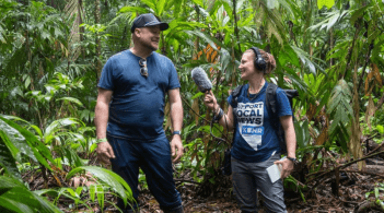 University of Nevada, Reno student Kat Fulwider, reporting from Costa Rica for KUNR. They are standing in a lush jungle.