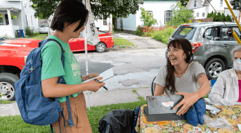Undergrad interviewing someone at farmers market