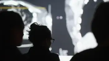 people viewing a screen with xray images