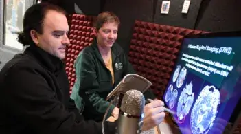 student and teacher working at a computer with imaging on the screen