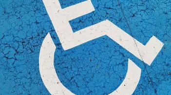 Close-up of an accessible parking logo painted on a parking space