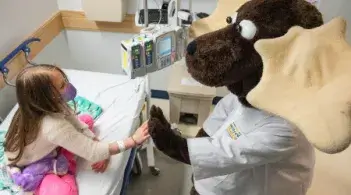 young patient greeting person in moose costume