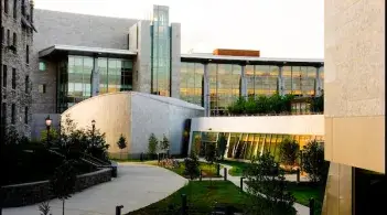Exterior picture of interconnected buildings of stone and glass
