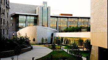 Exterior picture of interconnected buildings of stone and glass