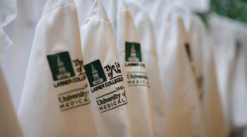 White Doctor's Coats with green Larner College of Medicine logo