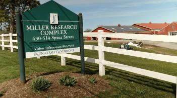 photo of the Miller Research Complex sign next to a white fence
