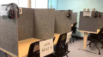 Cubicles with headphones and seats in a classroom
