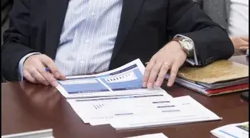 A person reviews paperwork at a desk