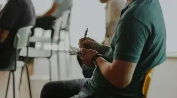 Person taking notes during a presentation