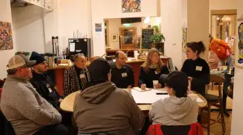 Group of adults talking around a table