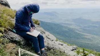 Catherine Wessel taking notes on top of Mt Mansfield