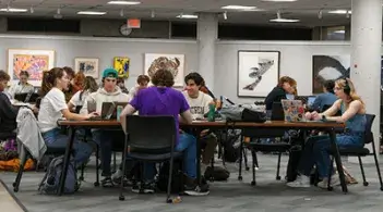 Students studying and working together in a campus academic space.