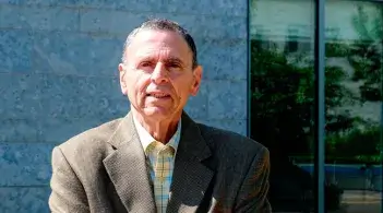 a man stands in front of a building 