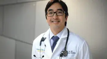 Dr. Benjamin Lee stands in a hallway