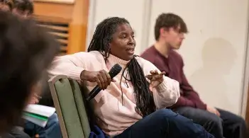 University of Vermont student participates in a conversation with a microphone