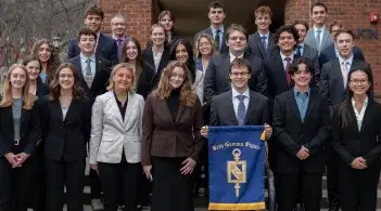 Beta Gamma Sigma inductees stand in front of Kalkin Hall