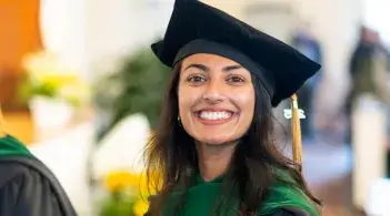woman in cap and gown with a big smile