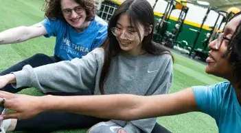 three people stretching