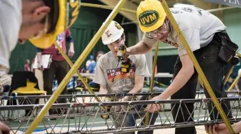 Students collaborate in a bridge building competition.