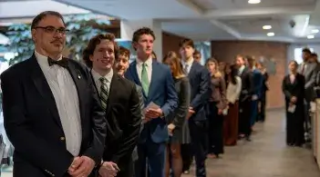 Prof. Michael Tomas heads up members of the Beta Gamma Sigma society in Ifshin Hall