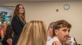 a young woman stands after being recognized at the 2026 Honors Awards Ceremony