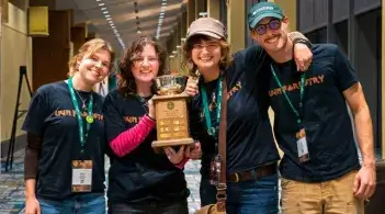 Four forestry students holding a trophy, their shirts say "UVM Forestry" photo by Wasim Muklashy courtesy of Society of American Foresters