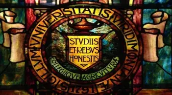 Close-up of the University of Vermont seal in stained glass.