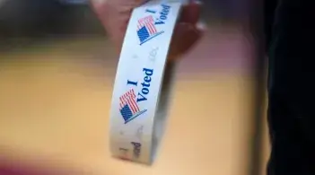 roll of "I voted" stickers in someone's hand