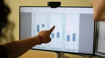person showing data results on a computer screen