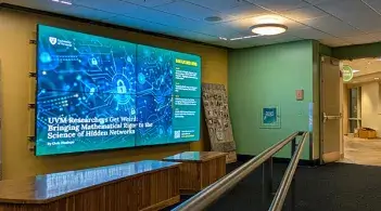 large flatscreen displaying news in a large green and gold room