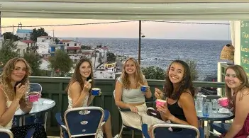 Students enjoy ice cream and an ocean view in Ikaria, Greece