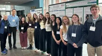 Exercise science faculty and students with a poster at the 2026 NEACSM conference
