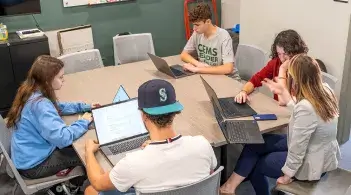 Student gather in the office of student success for advising meetings