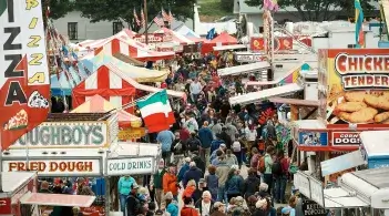 A crowd of Vermonters mingle among countless colorful food vendors at the Champlain valley fairgrounds