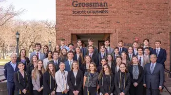 Beta Gamma Sigma inductees stand in front of Kalkin Hall